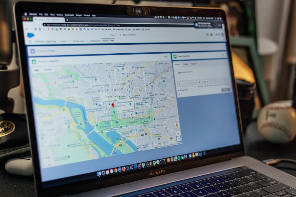 Laptop displaying a city map with a location pin – local business listings management